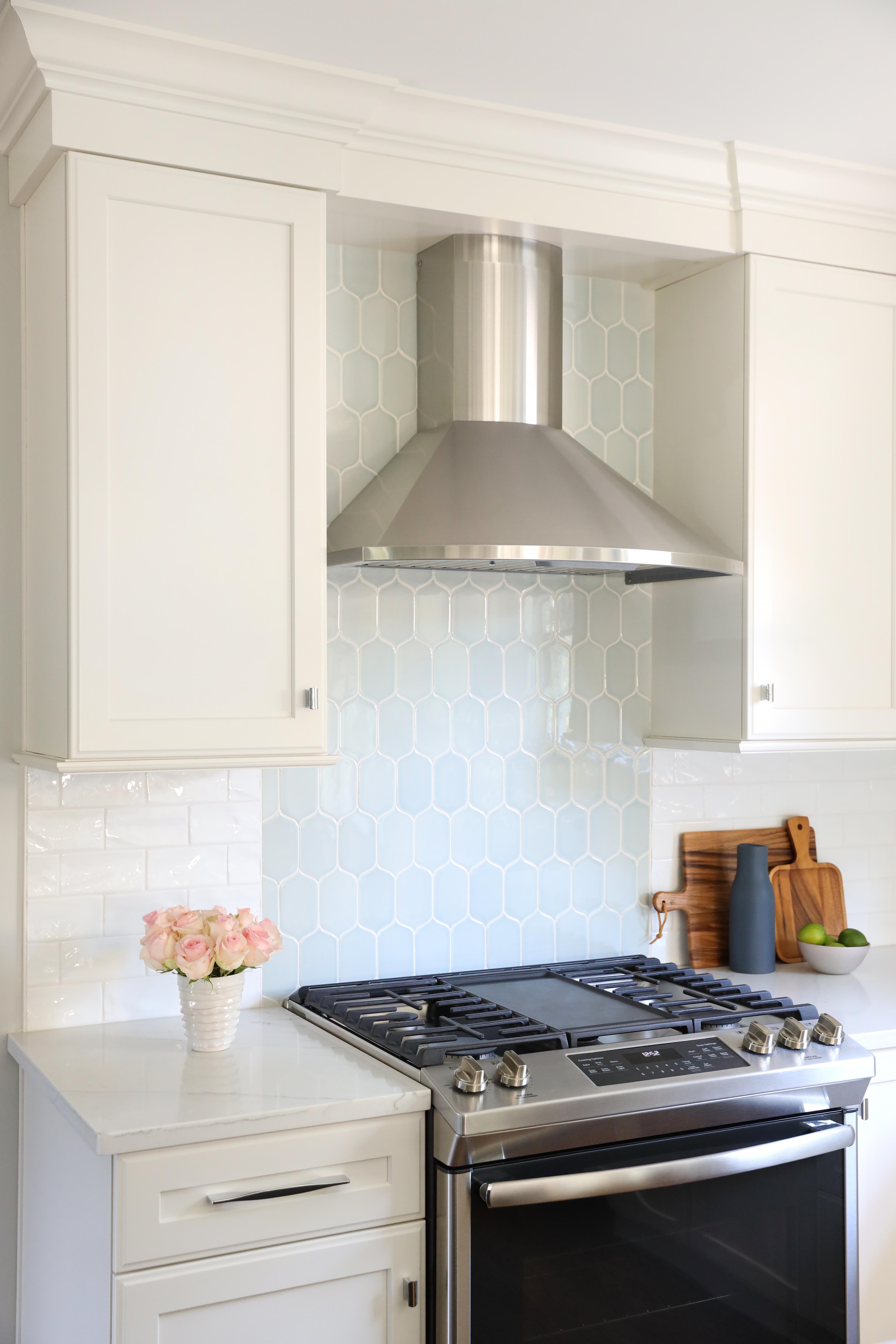 soft blue tile backsplash with stainless steel hood, white cabinetry