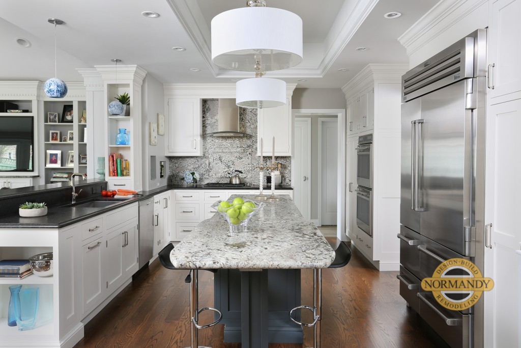 White kitchen with slab backsplash and dark island