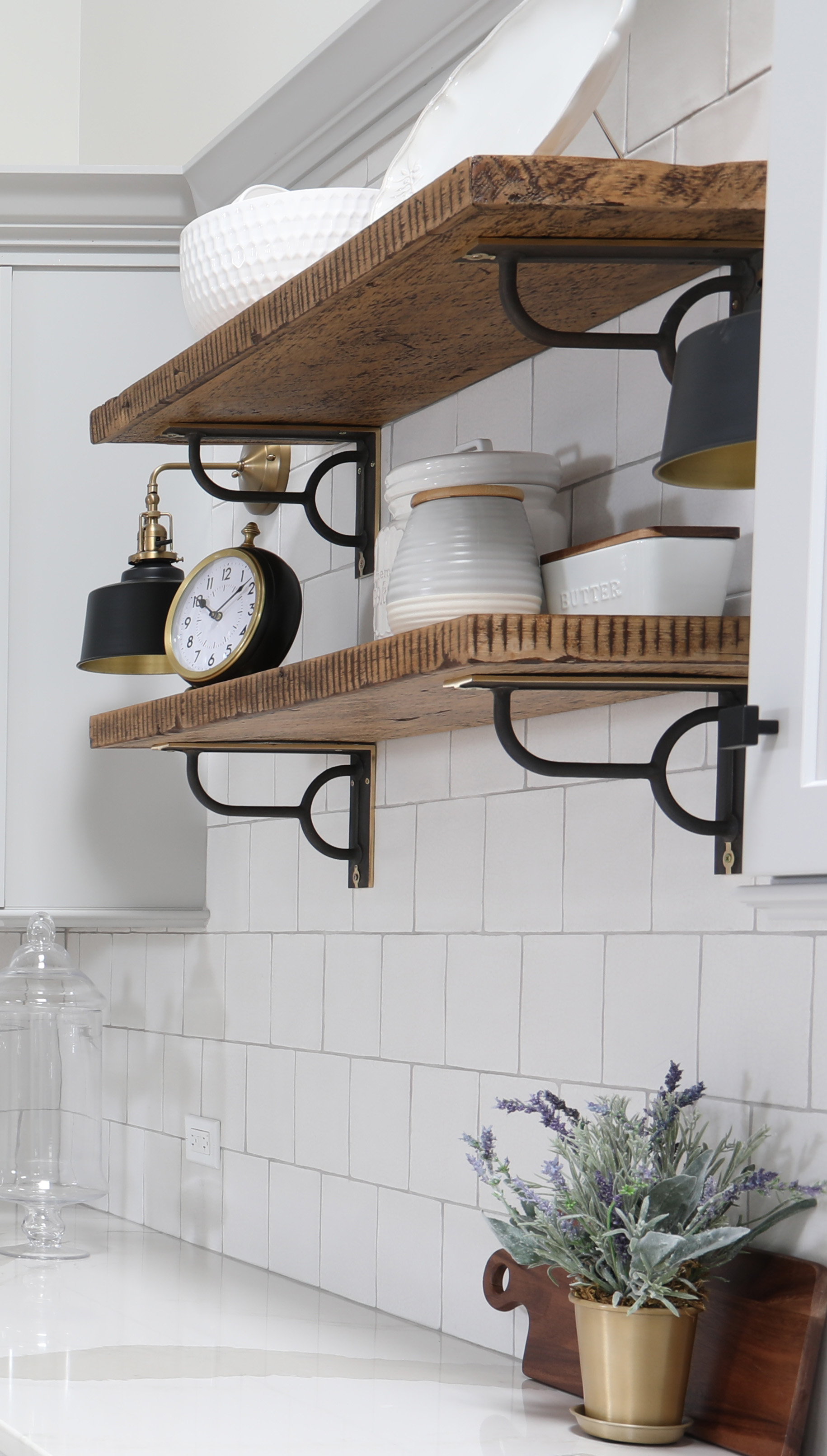 rustic wood open shelves on tiled wall in white kitchen 