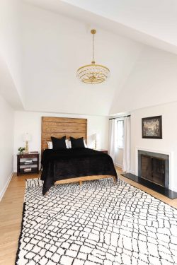 Primary bedroom with vaulted ceiling and fireplace