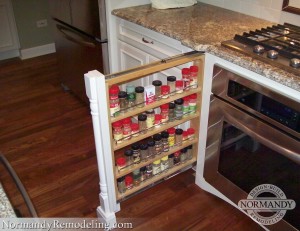 decorative cabinet column with pull out spice storage next to stove