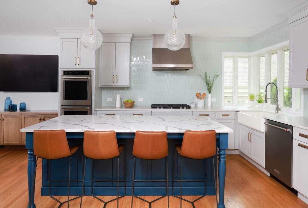 white kitchen with bold blue island and soft blue backsplash tile