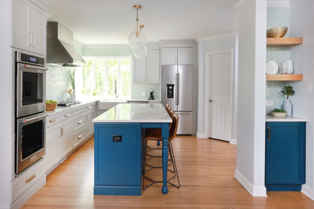 white kitchen with blue island and hall cabinet