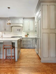 transitional kitchen with gray cabinetry and pot filler