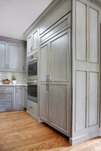 transitional kitchen in gray with warming drawer and paneled fridge