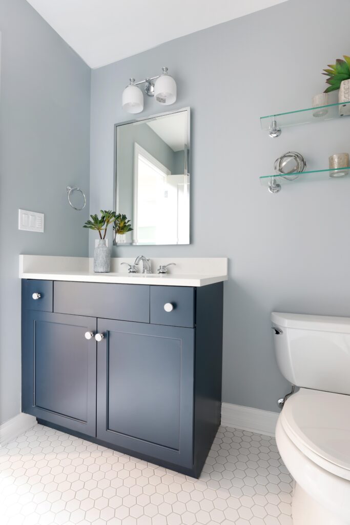 Kids hall bathroom with hex tile and blue vanity