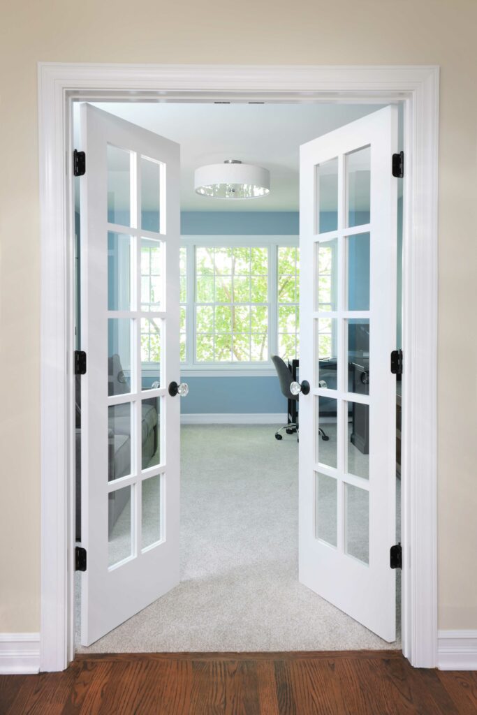 Bonus room with french doors, hardwood leading to carpet