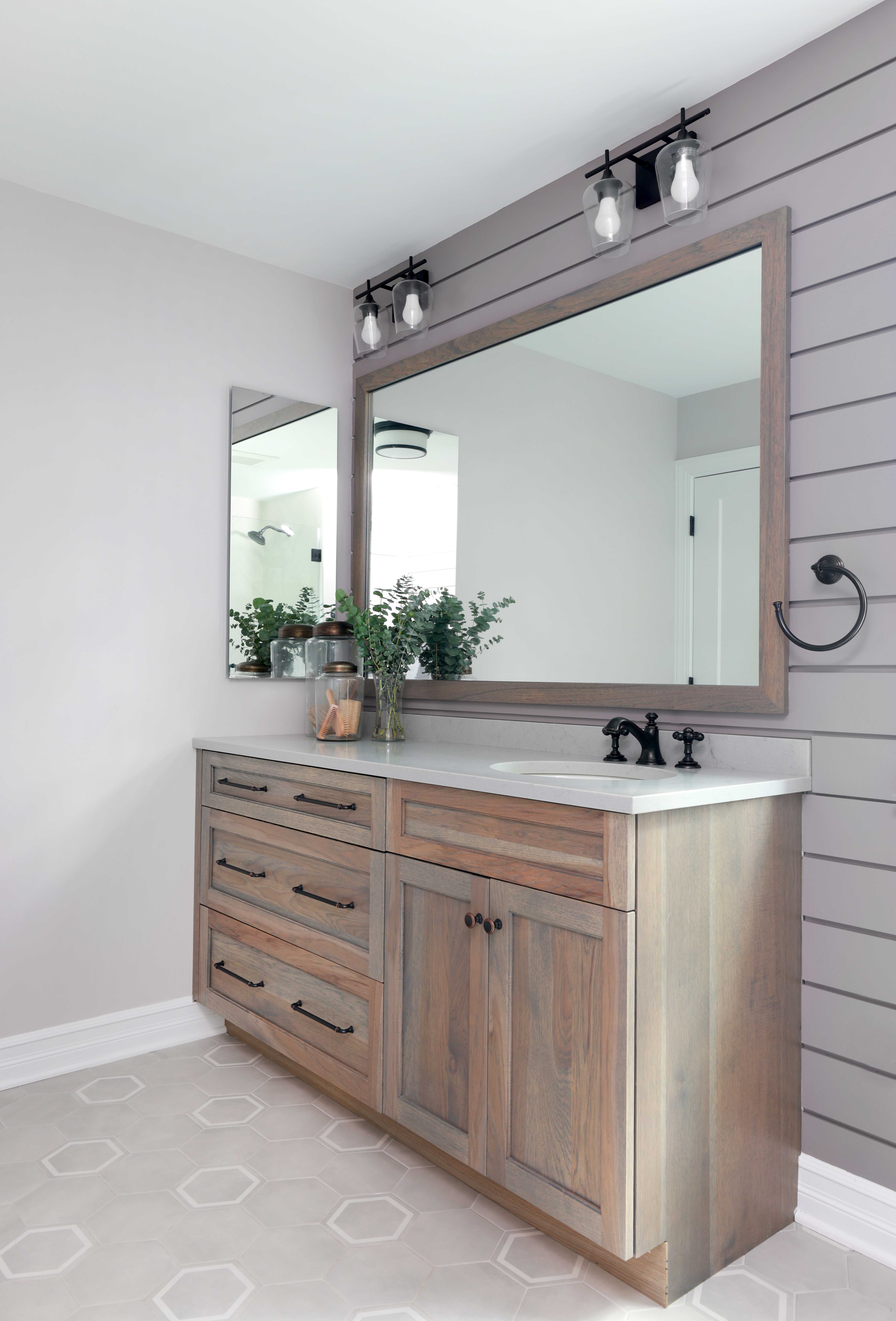 Hickory vanity and shiplap walls in a hall bathroom.