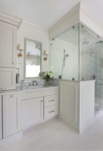 traditional bathroom in light gray with separate vanities and separate bathtub and shower