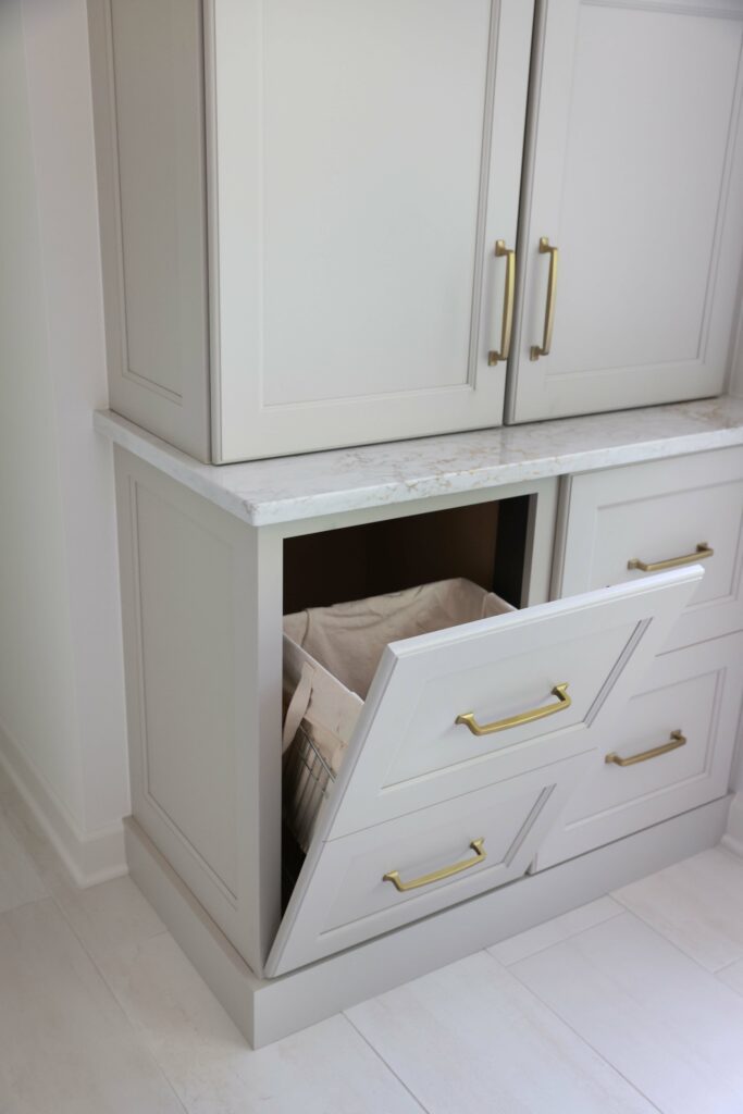 hidden tilt out hamper that looks like drawers are among top bathroom trends for 2023