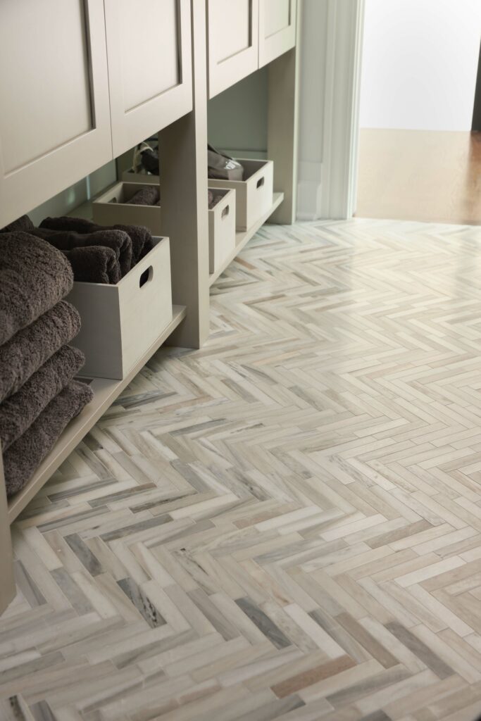 bathroom floor tile detail in slim herringbone pattern