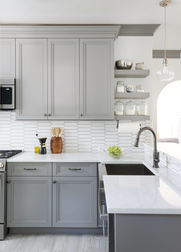 gray kitchen with open shelving and stainless steel sink