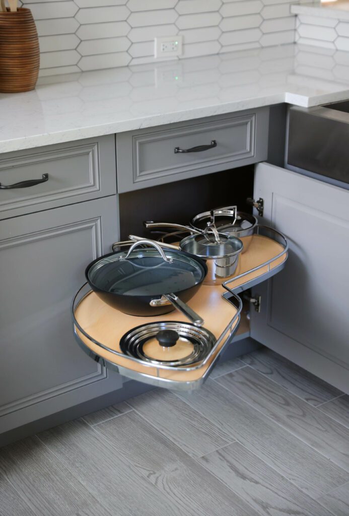 swing out cabinet shelf on lower cabinet in gray kitchen