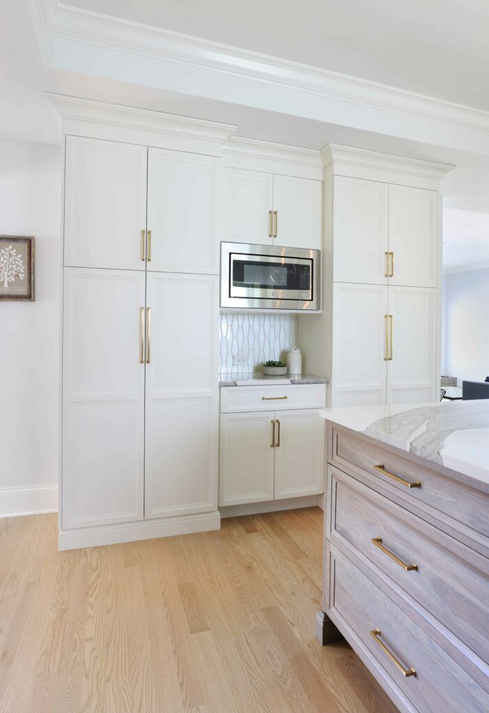 microwave area with counter and maple cabinetry and glass tile backsplash