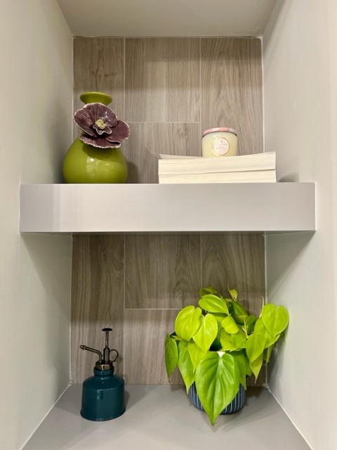 floating shelves with wood wall look