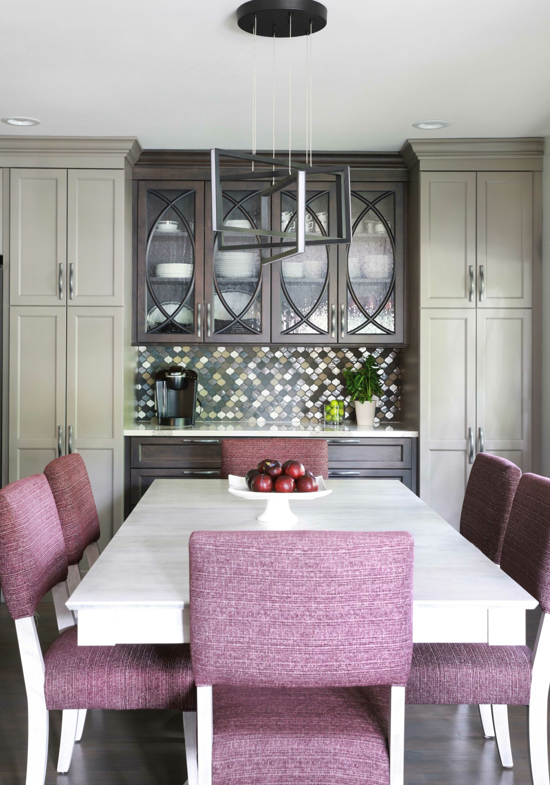 Gray painted and dark stained cabinetry buffet with kitchen table