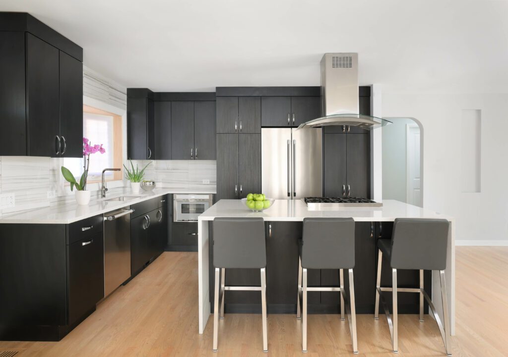 Modern kitchen with black cabinets and white countertops