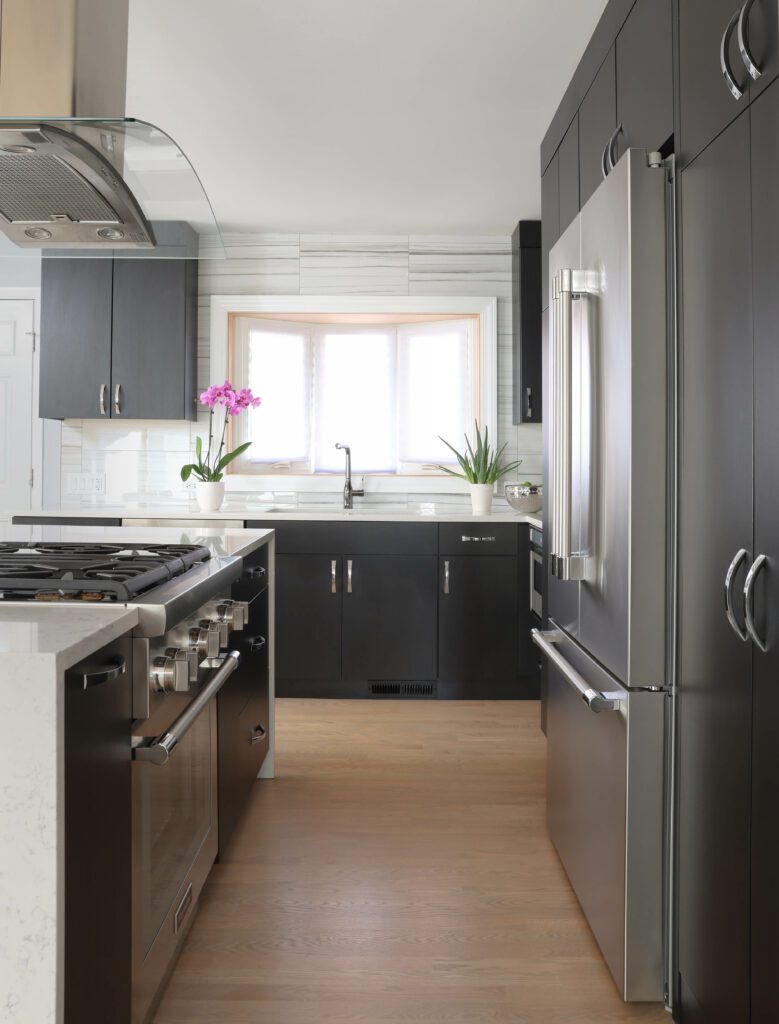 Modern kitchen with black slab cabinets showing the work triangle