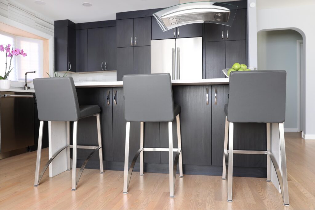 Black kitchen cabinetry with storage beneath the island