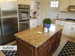 Before kitchen with dark island and white perimeter cabinets