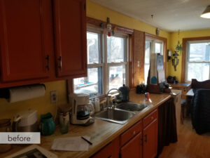 farmhouse kitchen BEFORE with outdated cabinetry and window above sink