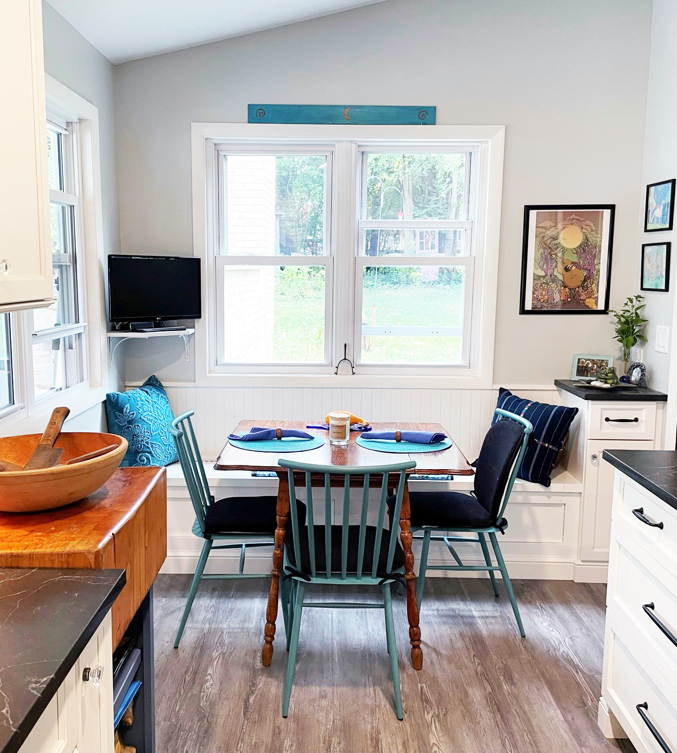 eat in area with window bench in white farmhouse kitchen