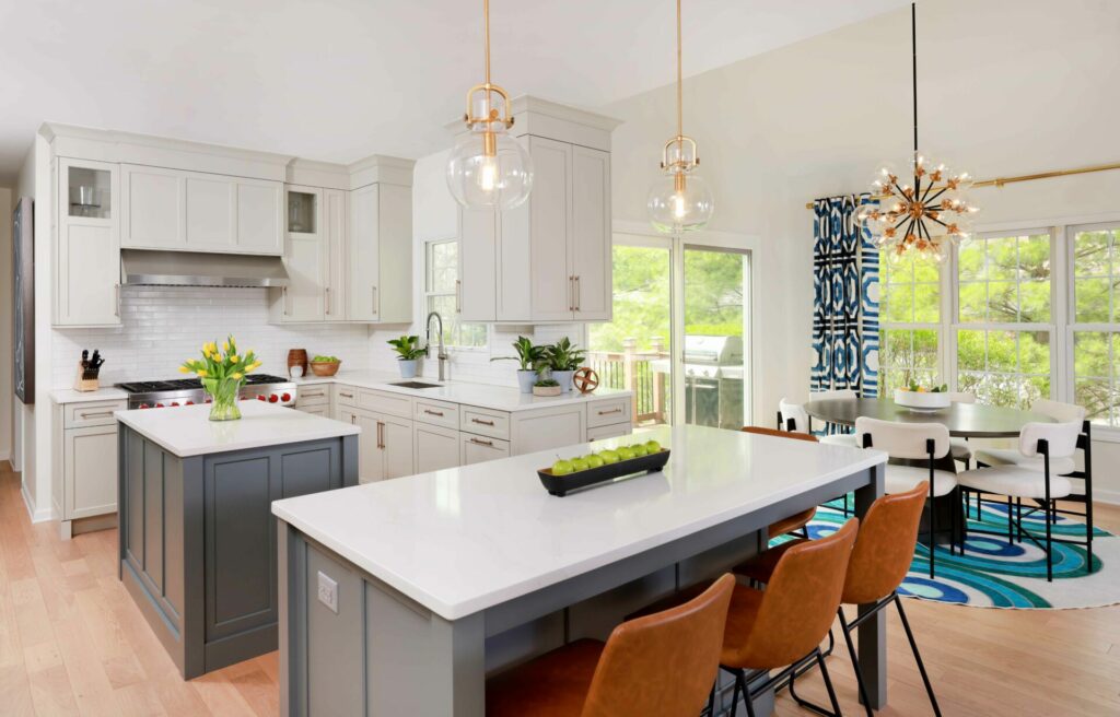 White kitchen with double islands and adjacent dining space