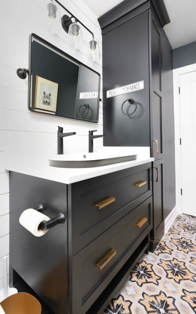 Black vanity with drop in sink in the bathroom