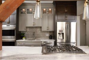 condo kitchen with down draft range and two tone cabinetry