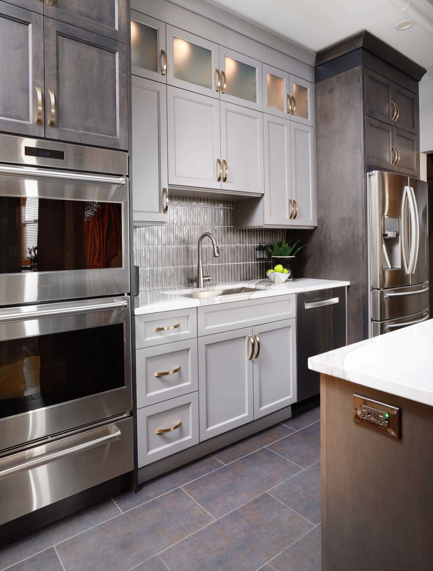 condo kitchen with two tone cabinetry and stainless steel appliances