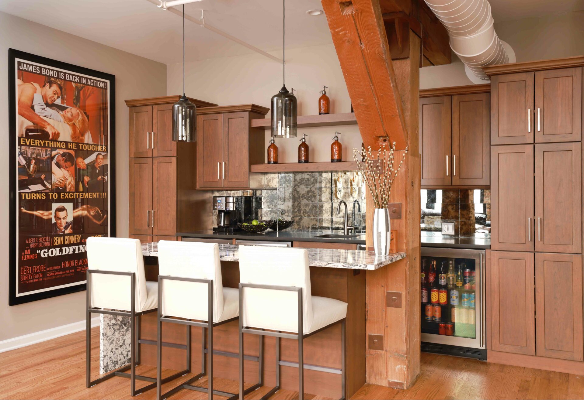 condo entertainment area with wet bar and island showcasing wooden support beam