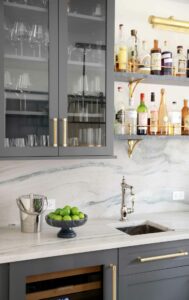 wet bar with painted cabinets and open shelving