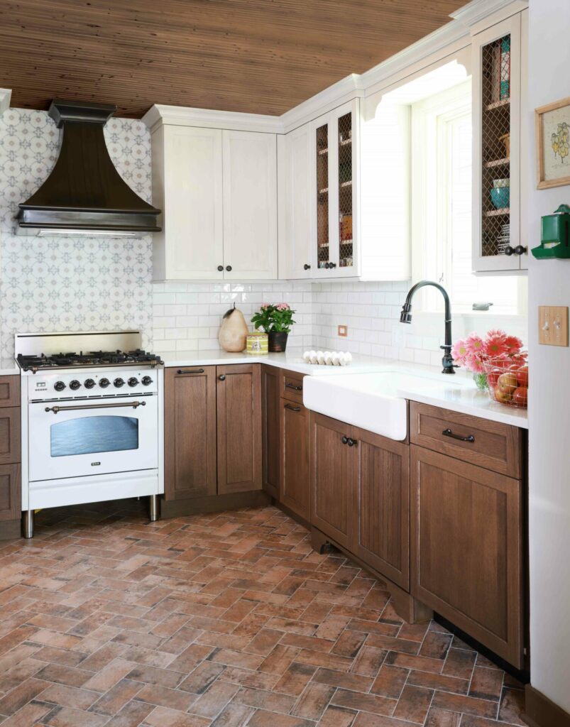 Stained lower kitchen cabinets with farmhouse sink and painted upper cabinets