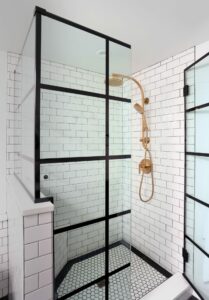 Shower with black grid and gold fixtures
