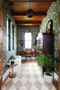 Small, cozy office with wood ceiling and decorative wallpaper