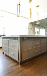 Rift cut white oak island in a light stain with decorative furniture legs