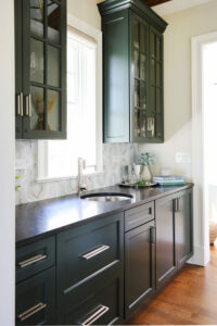 Home wet bar with dark cabinets