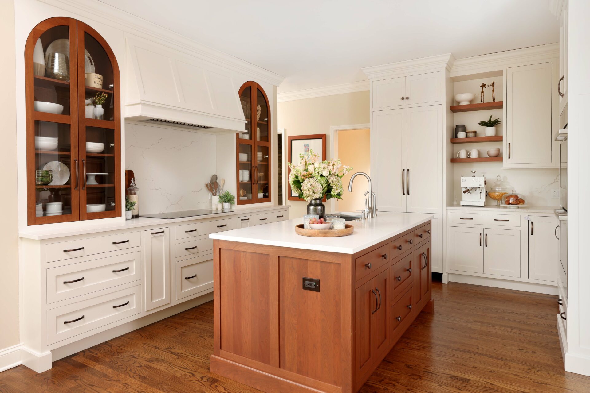 Winter white kitchen with stained cherry island and accent cabinetry