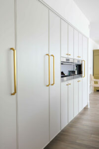 soft white kitchen cabinetry including paneled appliances