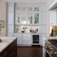 Light blue home bar with antique mirror glass doors to coordinate with light blue kitchen