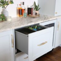 Dishwasher drawer in a soft blue wet bar as part of a traditional kitchen