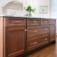 Stained walnut kitchen island in a traditional style kitchen design