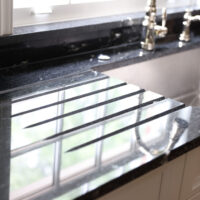 Built in dish dryer on black counterertop rack, dish dryer grooves, black countertop