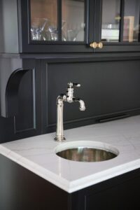 Circular bar sink, polished nickel, white countertops, black cabinets