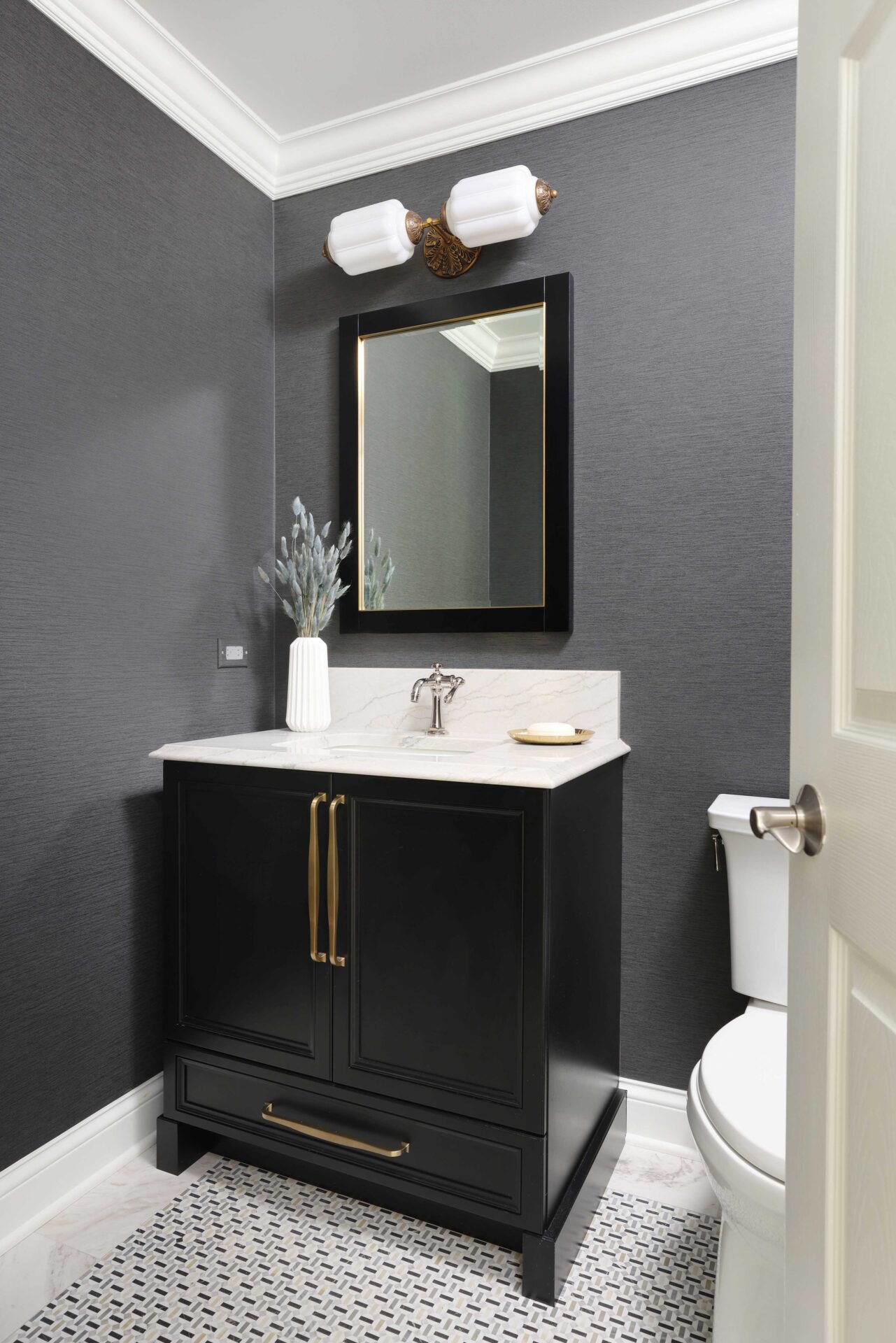 White countertops, gray walls, decorative light above mirror