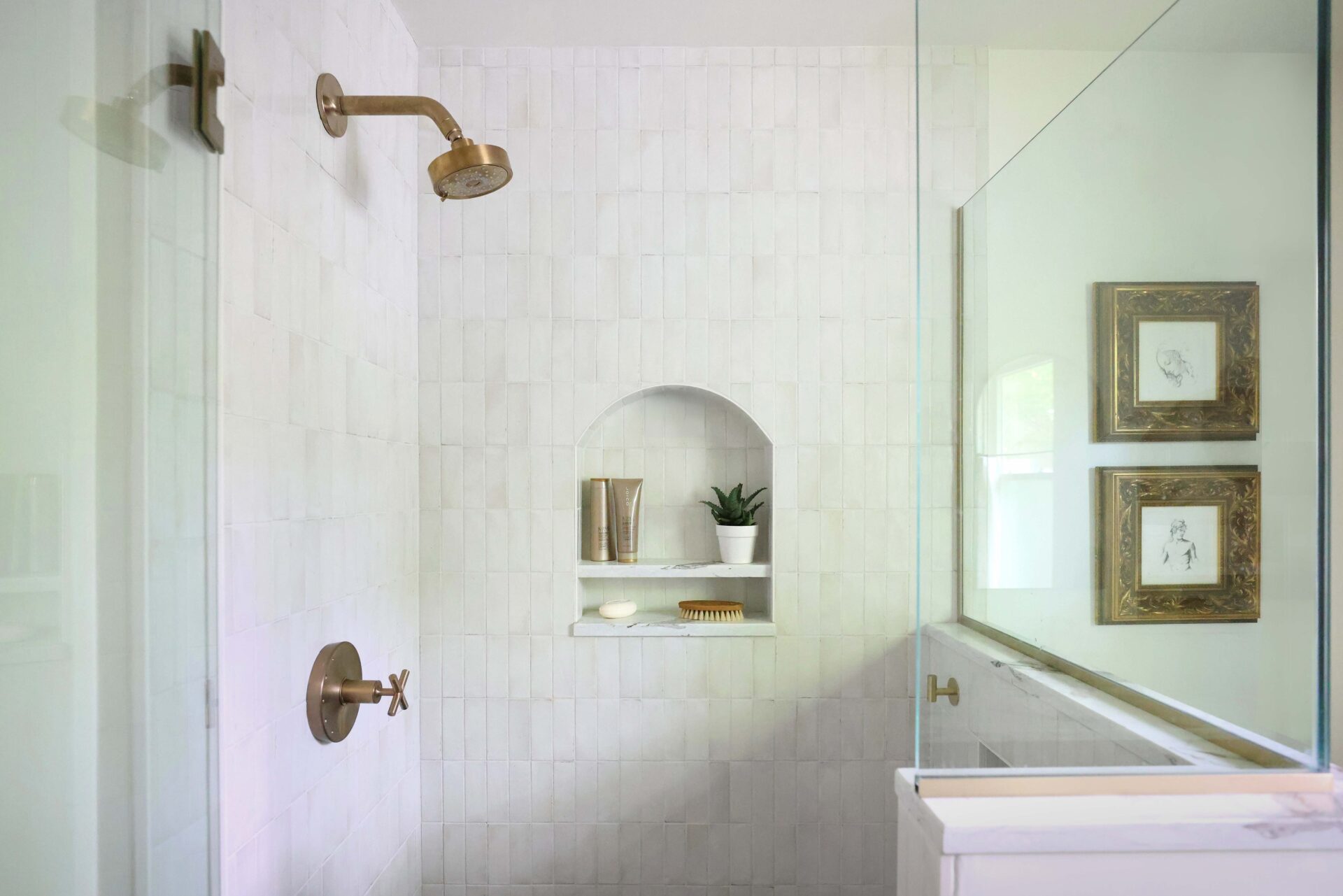 Arched shower niche, white tile, gold shower head