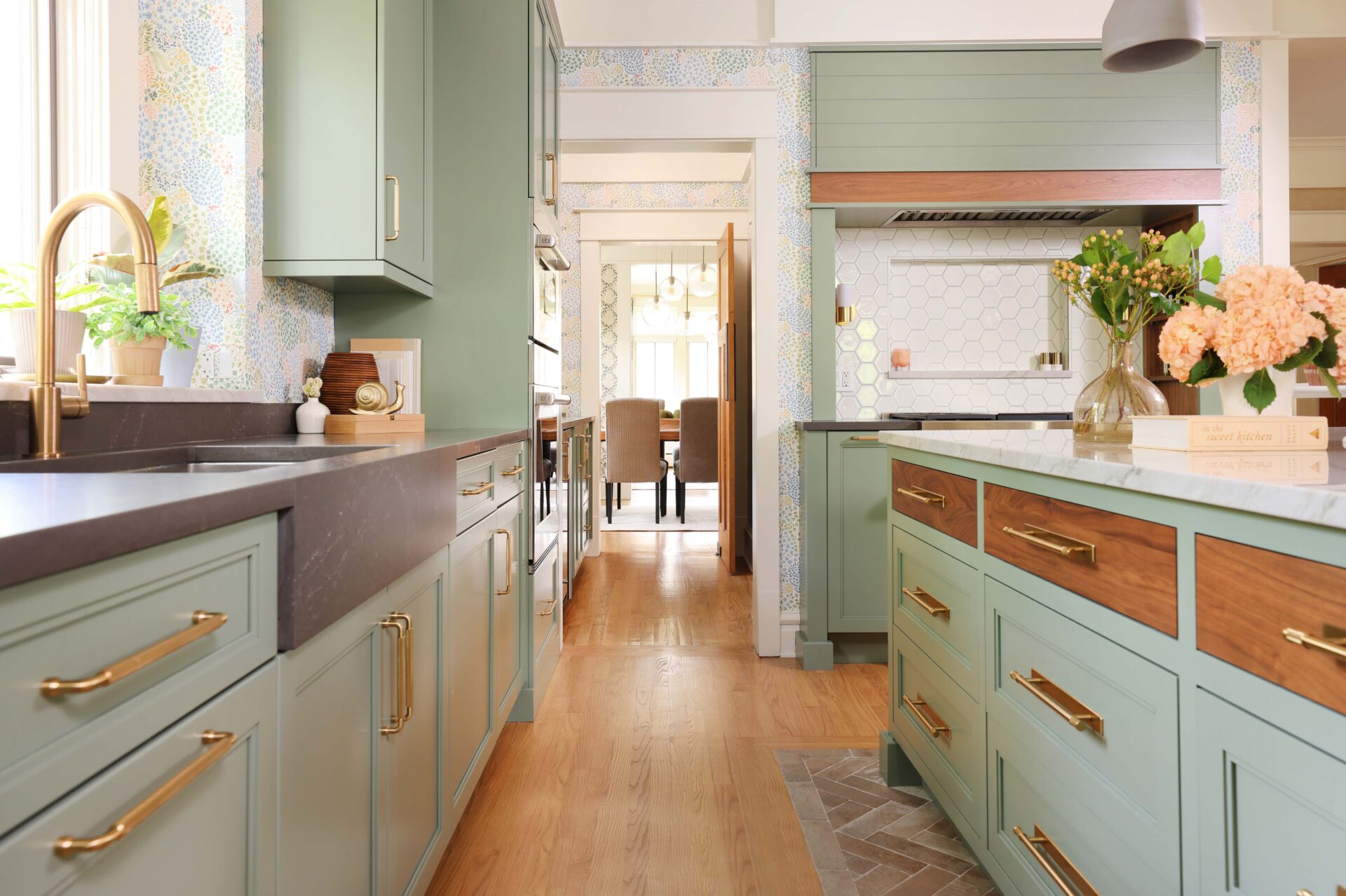 Green kitchen walnut inset drawers on kitchen island, quartz countertop apron style sink