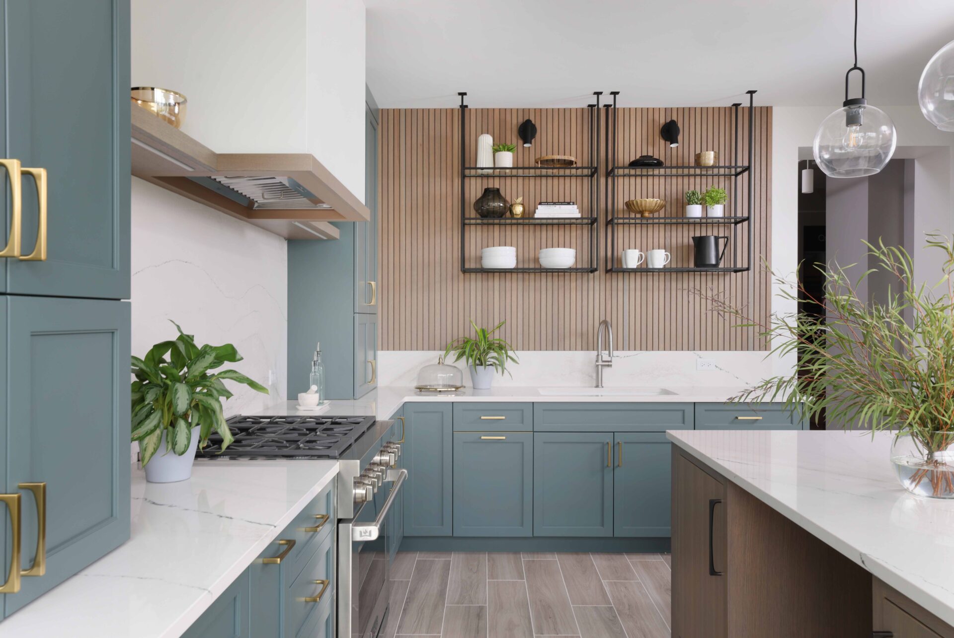 The color forward contemporary kitchen features sleek slab-front doors at the island — a modern take on inset cabinets, which typically leans more traditional — creating visual interest without overwhelming the space. Quartz countertops further balance the design with a calm, neutral surface.