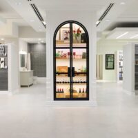 Display case with black metal and glass arch doors