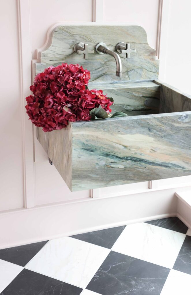 Garden estate butlers pantry features ice-gray enameled cast iron sink with wall mounted faucet in antique nickel. Also visible is coffered parquet tile floor.